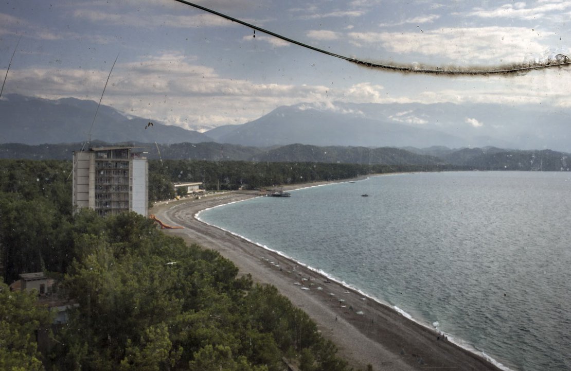 A view from the top, seen by a broken window glass, of the Pitsunda beach at the Black Sea.