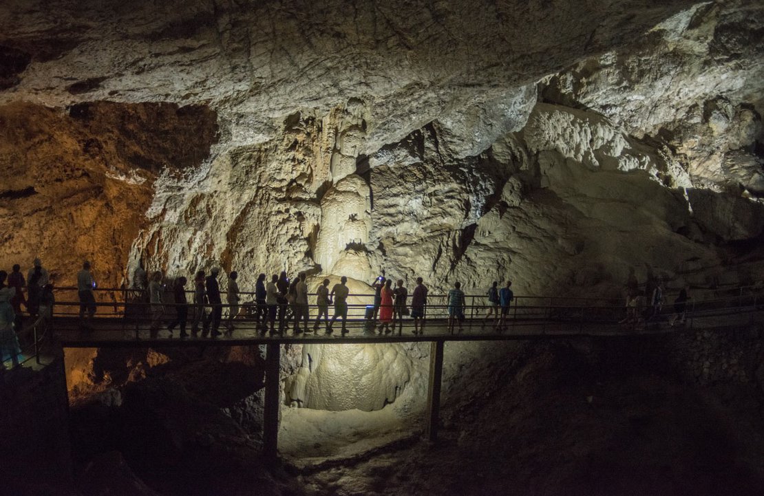 Tourist are visiting the Novi Afon Cave; a natural formation, known as the Skeleton, can be seen in the middle