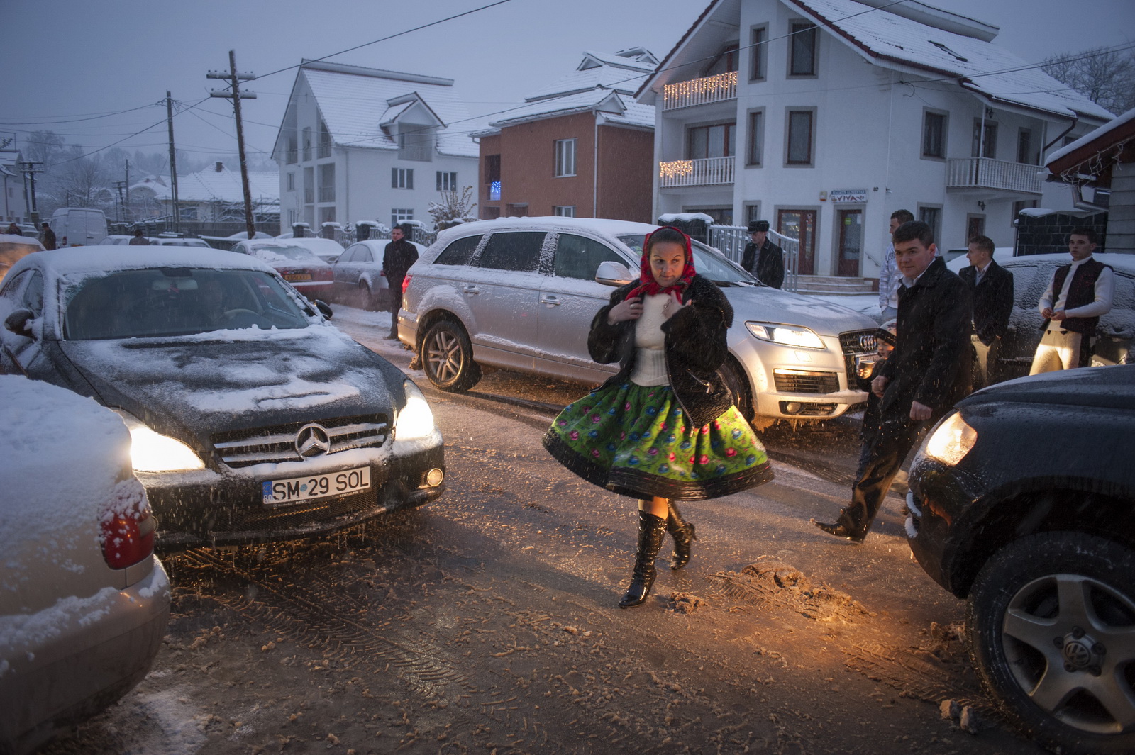 In all weathers: Villagers head to community centre in Tarsolt for a wedding (Photo © Petrut Calinescu)