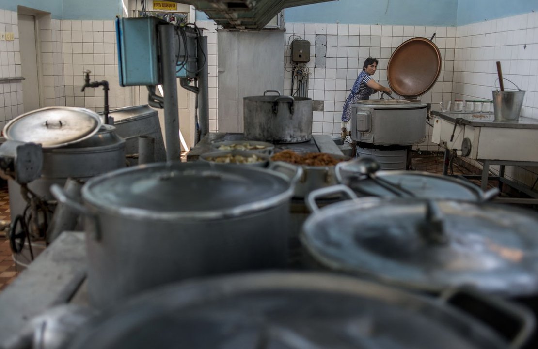 A woman works in the kitchen of the Chernomorets (Black Sea) Hotel, Gadauta.