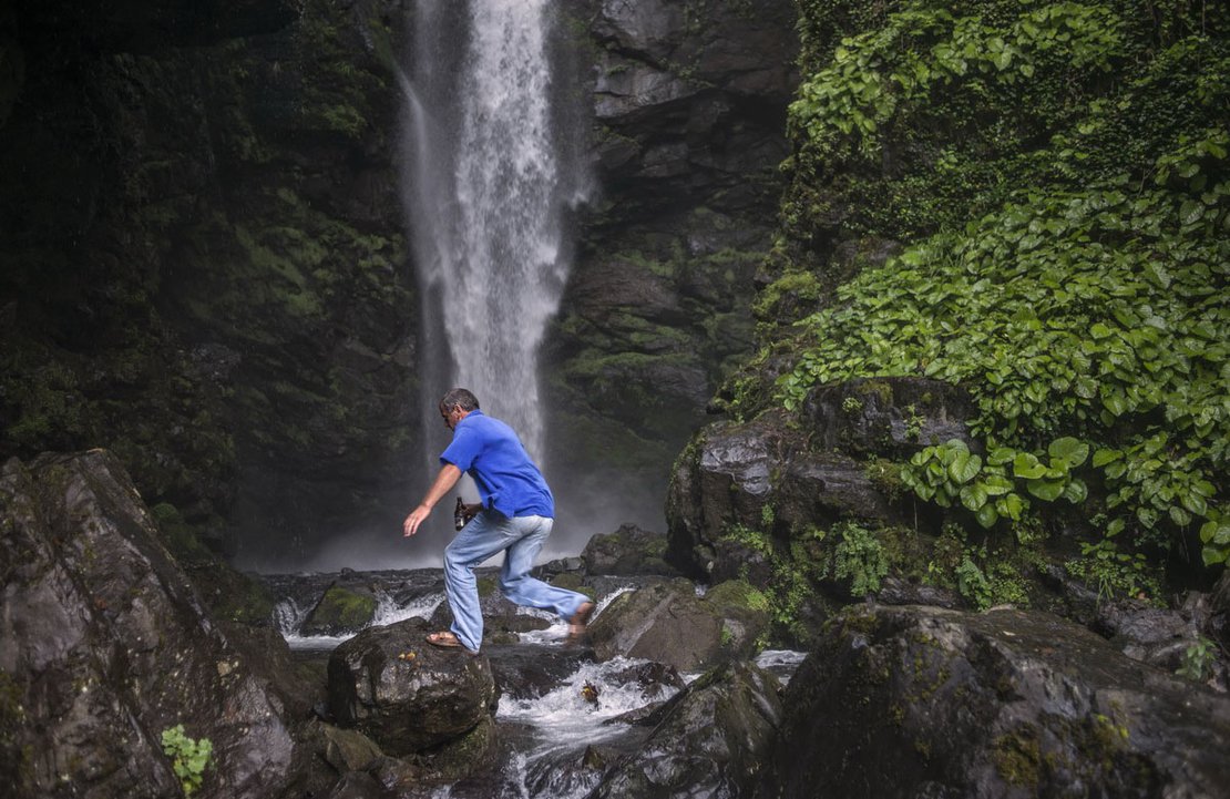 A man jumps through a waterfall on the outskirts of the collapsed ex-mining town of Tkvarcheli. This is a place popular for locals, where they often came for picnics or to stop, have a drink and enjoy the waterfall