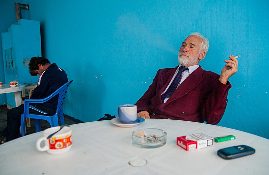 Octav Postolache, a man with a very interesting story and known as `the Professor` in the area, serves his morning coffee in the neighboring village, C.A. Rosetti, 2012.